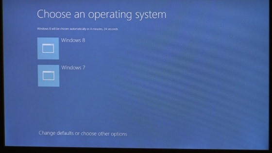 Dual boot options screen in Windows 8: “Choose an operating system” Icon 1: Windows 8; icon 2: Windows 7; Link to “Change defaults or choose other options”